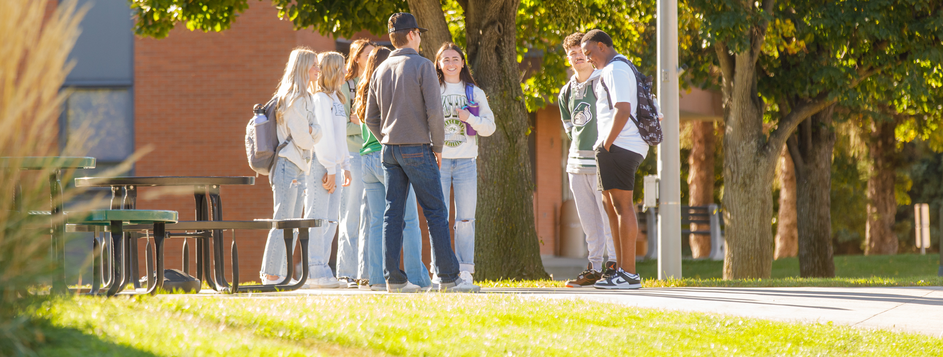 Students outside in a circle talking to each other